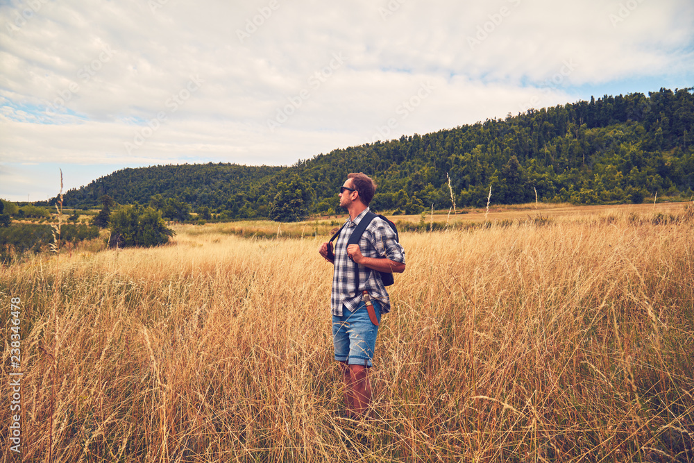 Hiker enjoying nice view in a hilly landscape. Hiker enjoying nice view in a hilly landscape.