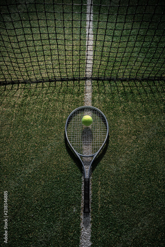 Tennis racket and ball on the court