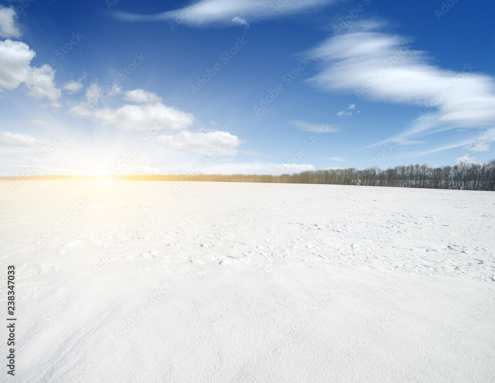 Snowcovered fields on  sky and sun.