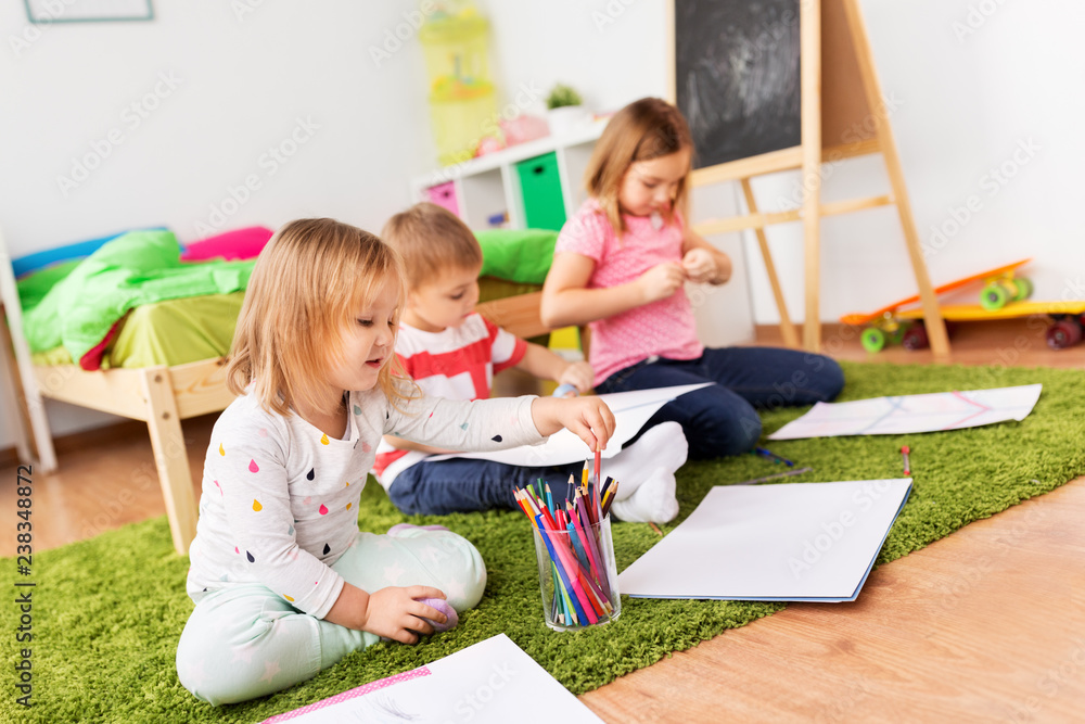 childhood, leisure and people concept - happy kids with crayons, paper and washi tape drawing and making crafts at home childhood, leisure and people concept - happy kids with crayons, paper and washi tape drawing and making crafts at home