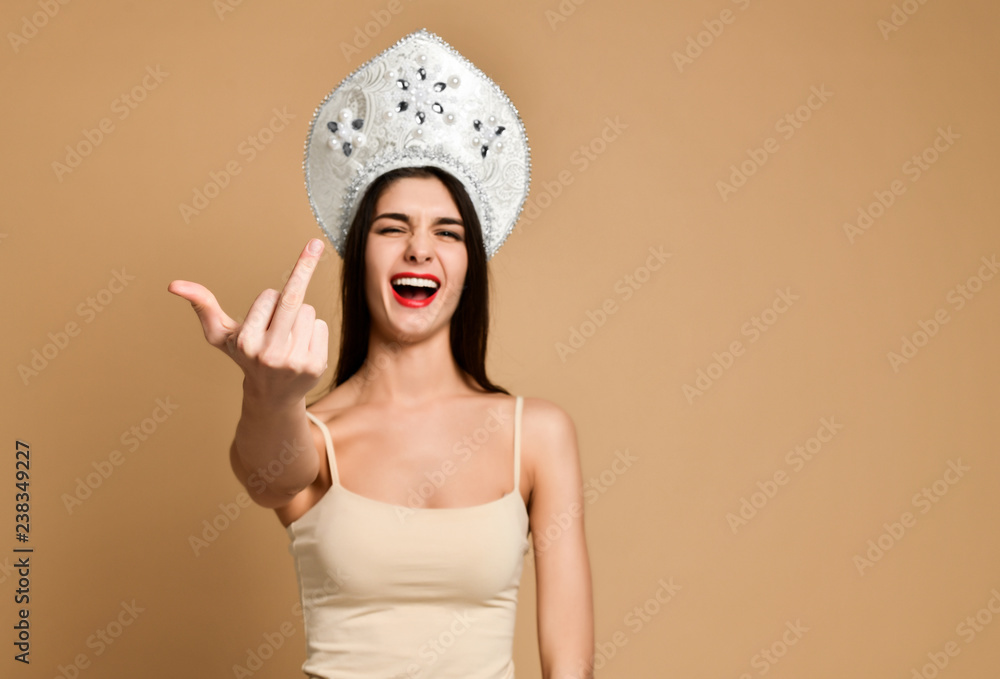 Crazy happiness woman showing fuck sign but not seriously. Indoor shot Crazy happiness woman showing fuck sign but not seriously. Indoor shot