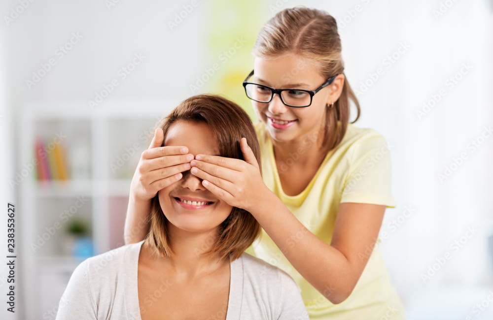 people and family concept - happy mother and daughter playing guess who game at home people and family concept - happy mother and daughter playing guess who game at home