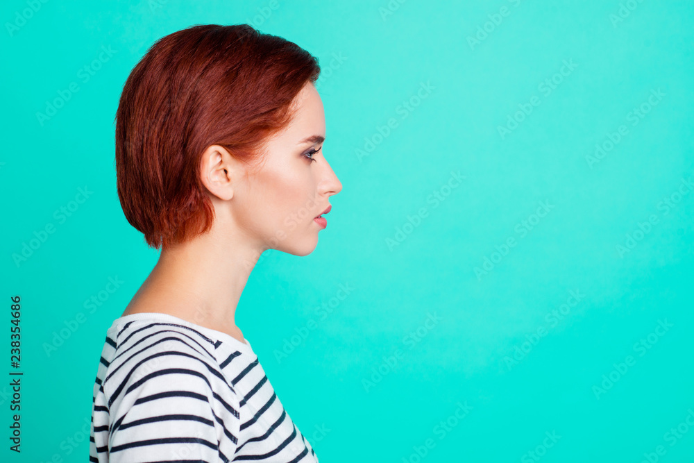 Fototapeta premium Profile side view portrait of nice charming pretty sweet attractive quiet minded red-haired lady wearing striped pullover isolated over bright vivid shine green turquoise background
