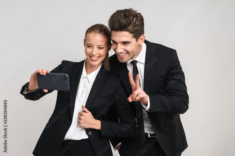 Portrait of a happy young business couple wearing suits Portrait of a happy young business couple wearing suits