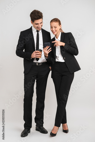Full length of confident young business couple
