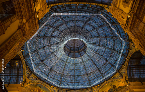 MILAN  ITALY  DECEMBER 5   2018 -  Glass skylight dome at arcade Galleria Vittorio Emanuele II illuminated with Christmas lights in Milan  Italy.