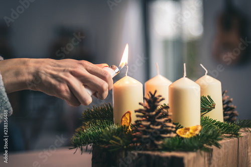 lighting a candle on advent wreath photo