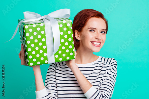 Close up portrait of attractive beautiful she her lady holding large giftbox in hands glad ready to unpack it wearing white striped sweater isolated on teal background