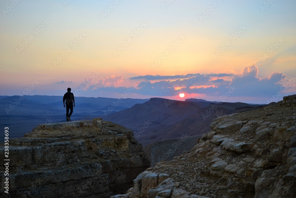 Sunset at Mitzpe Ramon crater, camel rock at Makhtesh Ramon, Negev desert, South Israel