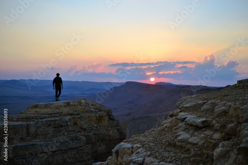Sunset at Mitzpe Ramon crater, camel rock at Makhtesh Ramon, Negev desert, South Israel © graceenee