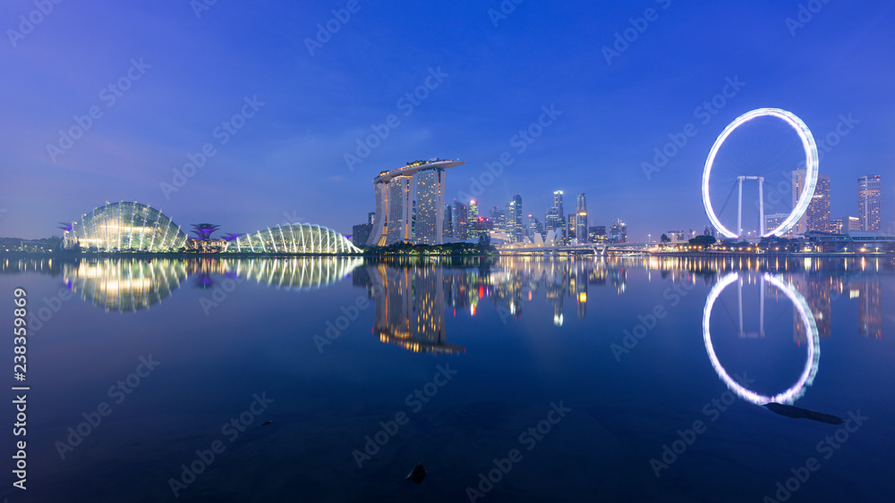 Singapore, 30 Oct 2018: a sunrise skyline view of the Marina Bay with the Garden domes, the Marina Bay Sands hotel and the Flyer Wheel in Singapore.