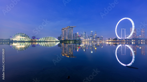 Singapore, 30 Oct 2018: a sunrise skyline view of the Marina Bay with the Garden domes, the Marina Bay Sands hotel and the Flyer Wheel in Singapore.