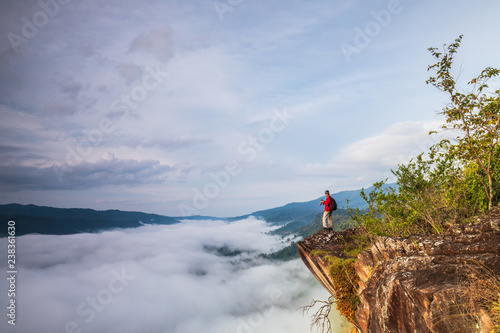 The man are taking photos  the sea of mist on high mountain in Nakornchoom, Phitsanulok province, Thailand.
