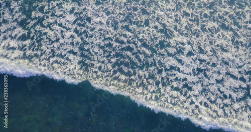 Aerial view beautiful of sea waves from drone. Stock image of blue color of ocean water, sea surface. Top view on turquoise waves, clear water surface texture. Top view, amazing nature background