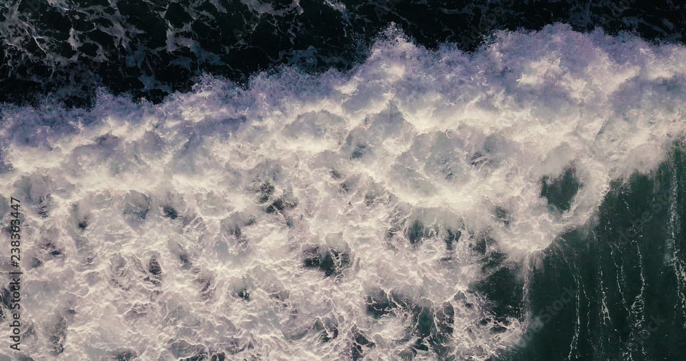 Aerial view beautiful of sea waves from drone. Stock image of blue color of ocean water, sea surface. Top view on turquoise waves, clear water surface texture. Top view, amazing nature background Aerial view beautiful of sea waves from drone. Stock image of blue color of ocean water, sea surface. Top view on turquoise waves, clear water surface texture. Top view, amazing nature background