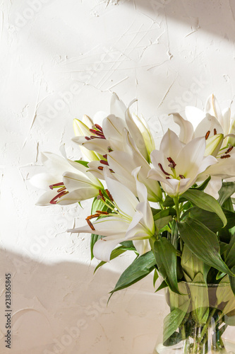 Fototapeta Naklejka Na Ścianę i Meble -  Flower bouquet, white lilies in a vase. White background. 