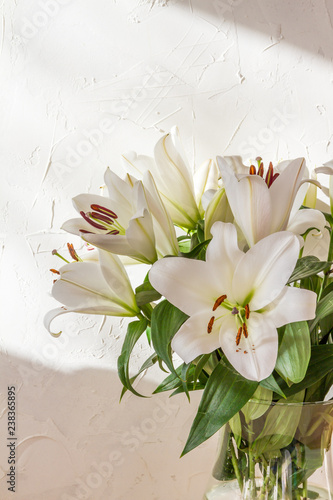 Flower bouquet, white lilies in a vase. White background. 