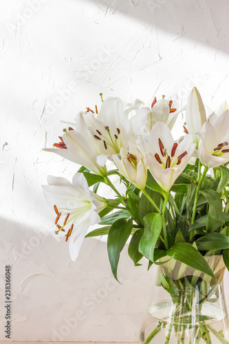 Fototapeta Naklejka Na Ścianę i Meble -  Flower bouquet, white lilies in a vase. White background.