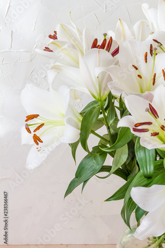 Fototapeta Naklejka Na Ścianę i Meble -  Flower bouquet, white lilies in a vase. White background.