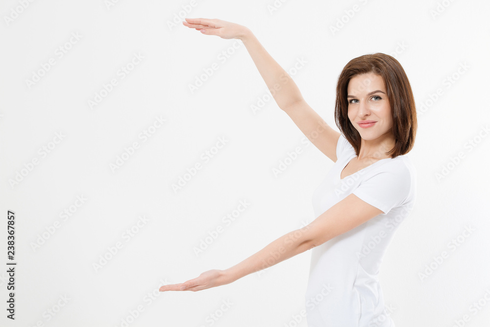 Caucasian girl in tshirt isolated on white background showing copy space by hands. European young woman. Mock up. Caucasian girl in tshirt isolated on white background showing copy space by hands. European young woman. Mock up.