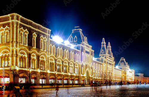Moscow, Russia - December 1, 2018: Facade view of GUM department store with moving people from Red Square at night 
