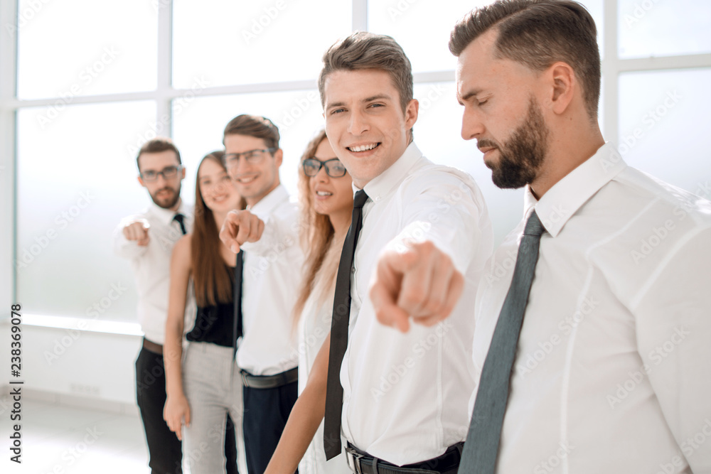 business team standing in new office and pointing forward business team standing in new office and pointing forward