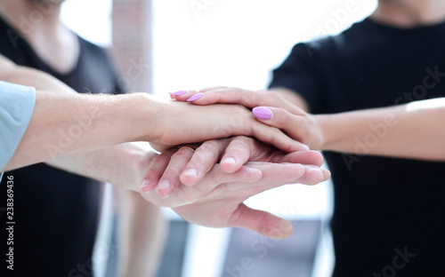 Closeup of a business colleagues with their hands stacked togeth