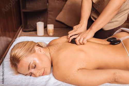Joyful relaxed woman visiting a massage salon