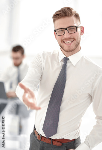 close up.business man holding out his hand for a handshake