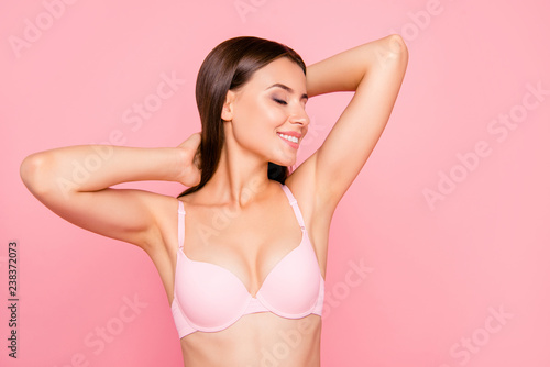 Close up portrait of gorgeous skinny cute lovely her she girl in salon relaxing of aroma sensitive procedure clear clean concept in bra eyes closed hands behind head isolated on pink background photo