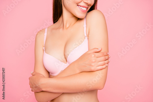 Cropped close up portrait of nice lovely gorgeous cute her she girl enjoying perfect softness of skin touching in pale pink bra isolated on pink background photo
