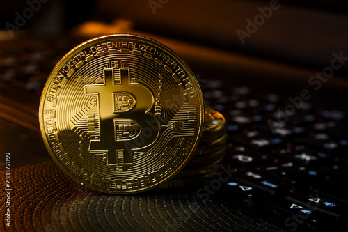 Gold coins cryptocurrency lie on the laptop keyboard