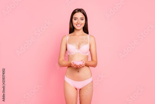 Portrait of nice lovely adorable attractive feminine gorgeous magnificent cheerful girl in beige lingerie holding in hands gel jar isolated over pink pastel background © deagreez