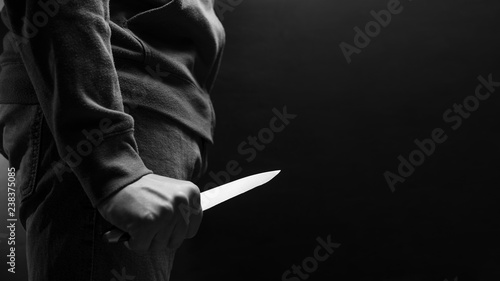The criminal with a knife weapon threatens to kill. With space for an inscription. News staties, newspaper, social issues, the increase in severity photo