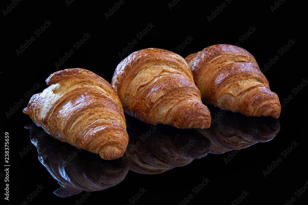 Сroissants of puff pastry on a black background