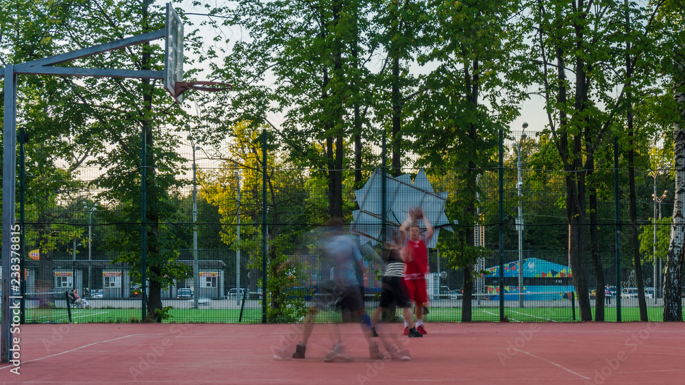 Fototapeta premium young people enthusiastically play street basketball