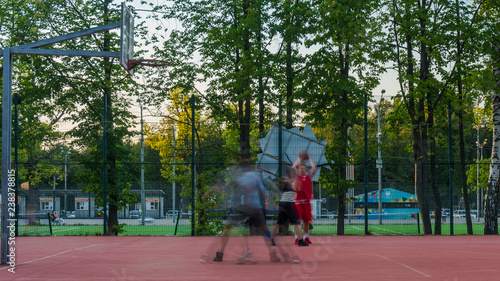 young people enthusiastically play street basketball