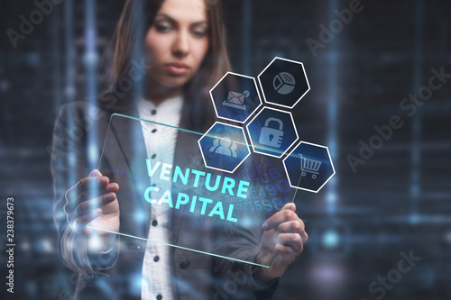 The concept of business, technology, the Internet and the network. A young entrepreneur working on a virtual screen of the future and sees the inscription: Venture capital