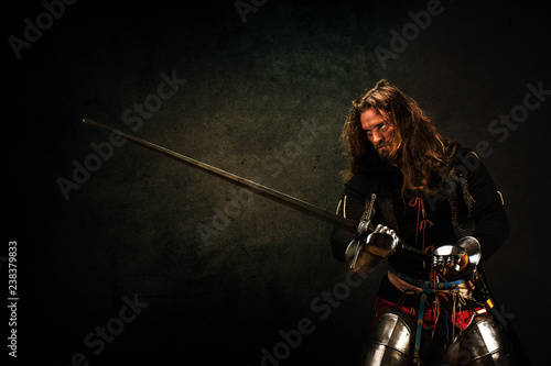 Portrait of a knight armed with a claymore