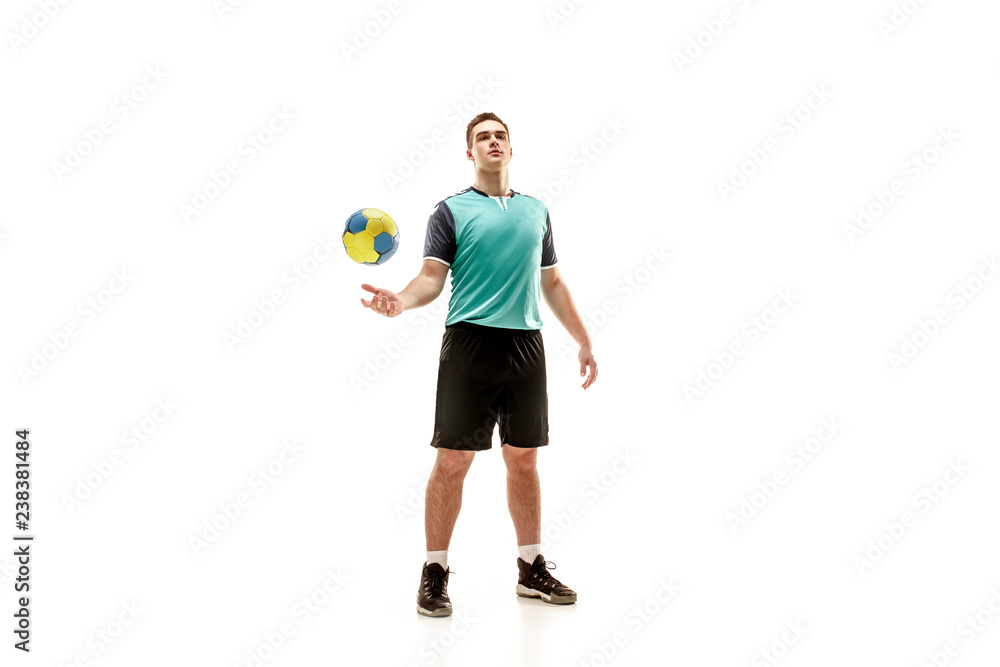 The fit caucasian young male handball player at studio on white background