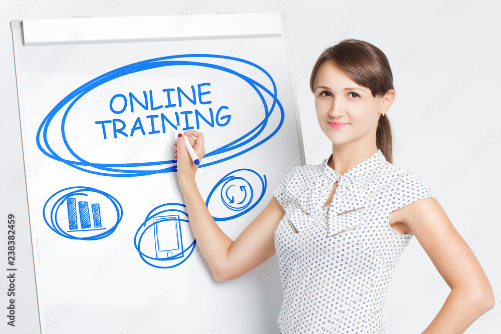 Business, Technology, Internet and network concept. A young entrepreneur writes on the blackboard the word: Online training Business, Technology, Internet and network concept. A young entrepreneur writes on the blackboard the word: Online training