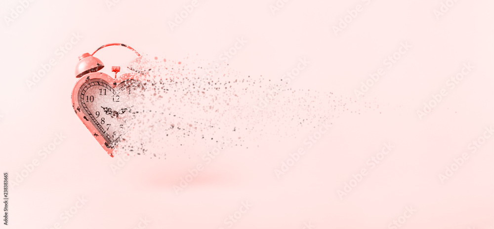 Φωτογραφία Heart shaped clock dispersing on pink background