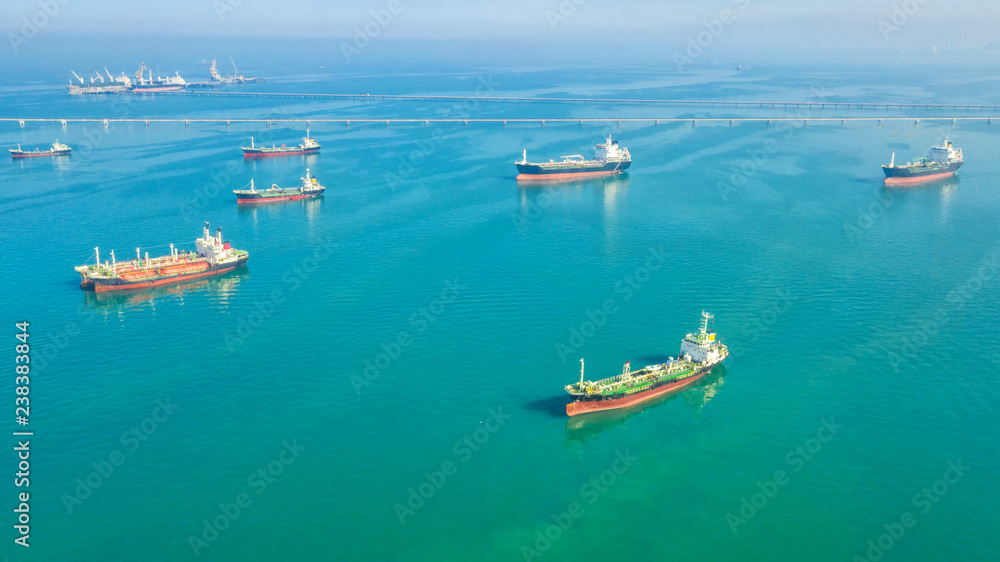Oil tanker, gas tanker in the high sea.Refinery Industry cargo ship,aerial view,Thailand, in import export, LPG,oil refinery, Logistics and transportation with working crane bridge in harbor Oil tanker, gas tanker in the high sea.Refinery Industry cargo ship,aerial view,Thailand, in import export, LPG,oil refinery, Logistics and transportation with working crane bridge in harbor
