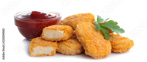Fotografia chicken nuggets with red ketchup sauce on white isolated background