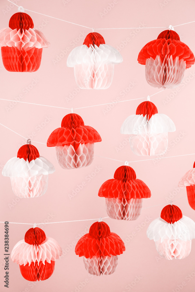 Obraz premium Paper cupcakes celebration decoration. Holiday party concept . Living coral theme - color of the year 2019