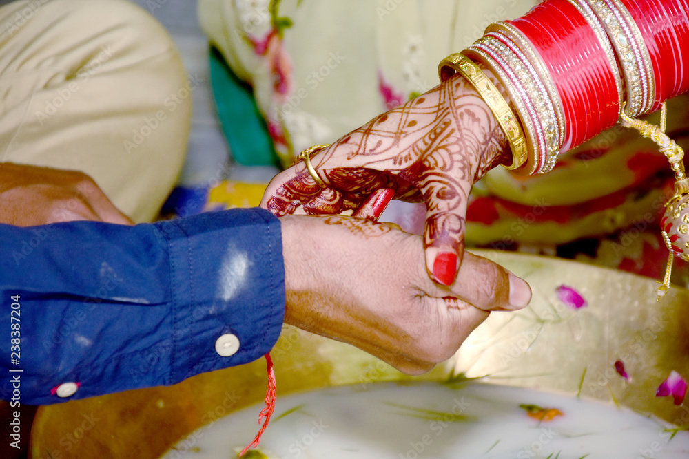 Fototapeta premium Indian couple playing Ring Fishing game in wedding ceremony of India