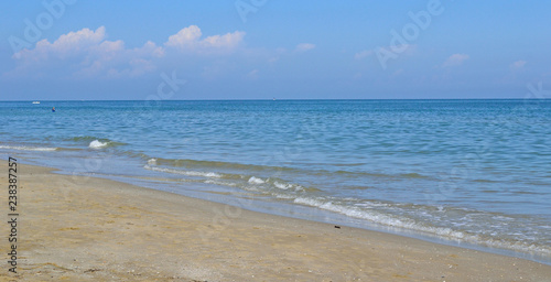 Landscape of sandy beach and light storm on the sea, background