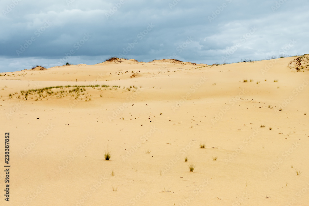 The sandy desert surface and stormy cloudy sky. Forthcoming raining in the waterless land. Rostov-on-don region, Russia