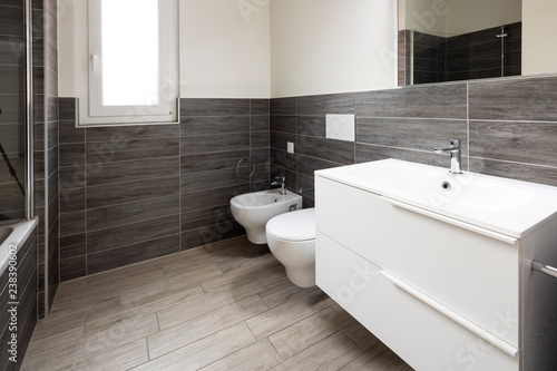 Bathroom with elegant minimalist brown tiles