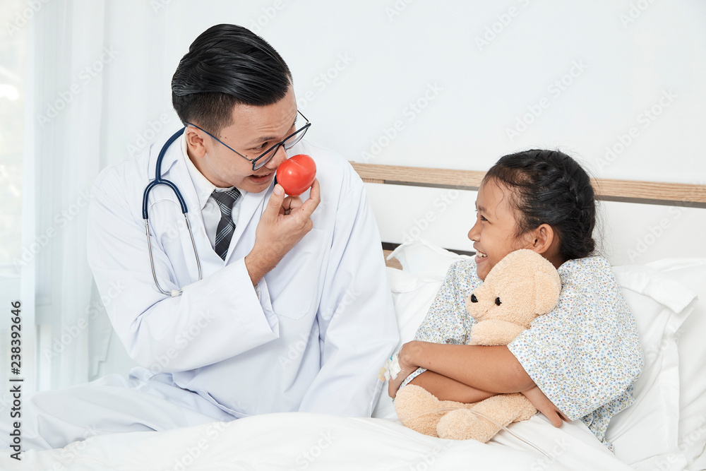 Young male doctor pediatrician checking girl Young male doctor pediatrician checking girl